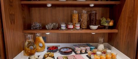 A breakfast buffet with various food items and beverages.