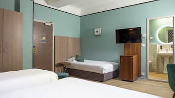 A hotel room with two beds, a television, a mirror, and a small refrigerator.