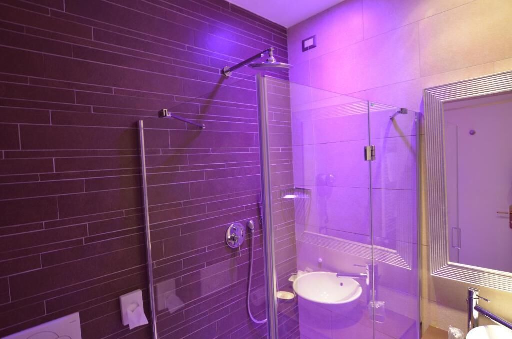 deluxe single room | bathroom | deep-soaking bathtub, rainfall showerhead, free toiletries, hair dryer