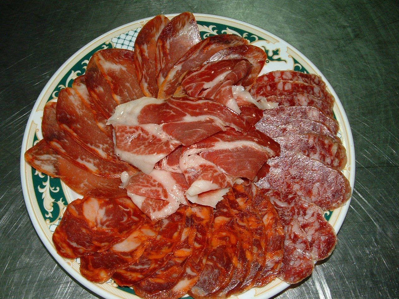 A plate of sliced cured meats.