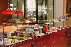 A buffet with various food items and condiments. - El Sant Cugat (Sant Cugat del Valles)