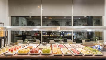 A buffet with various food items and a coffee station.