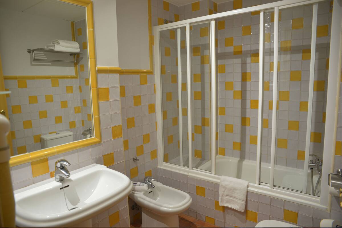 superior quadruple room | bathroom | shower, hair dryer, towels