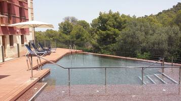 Seasonal outdoor pool, open 11:00 AM to 8:00 PM, pool umbrellas