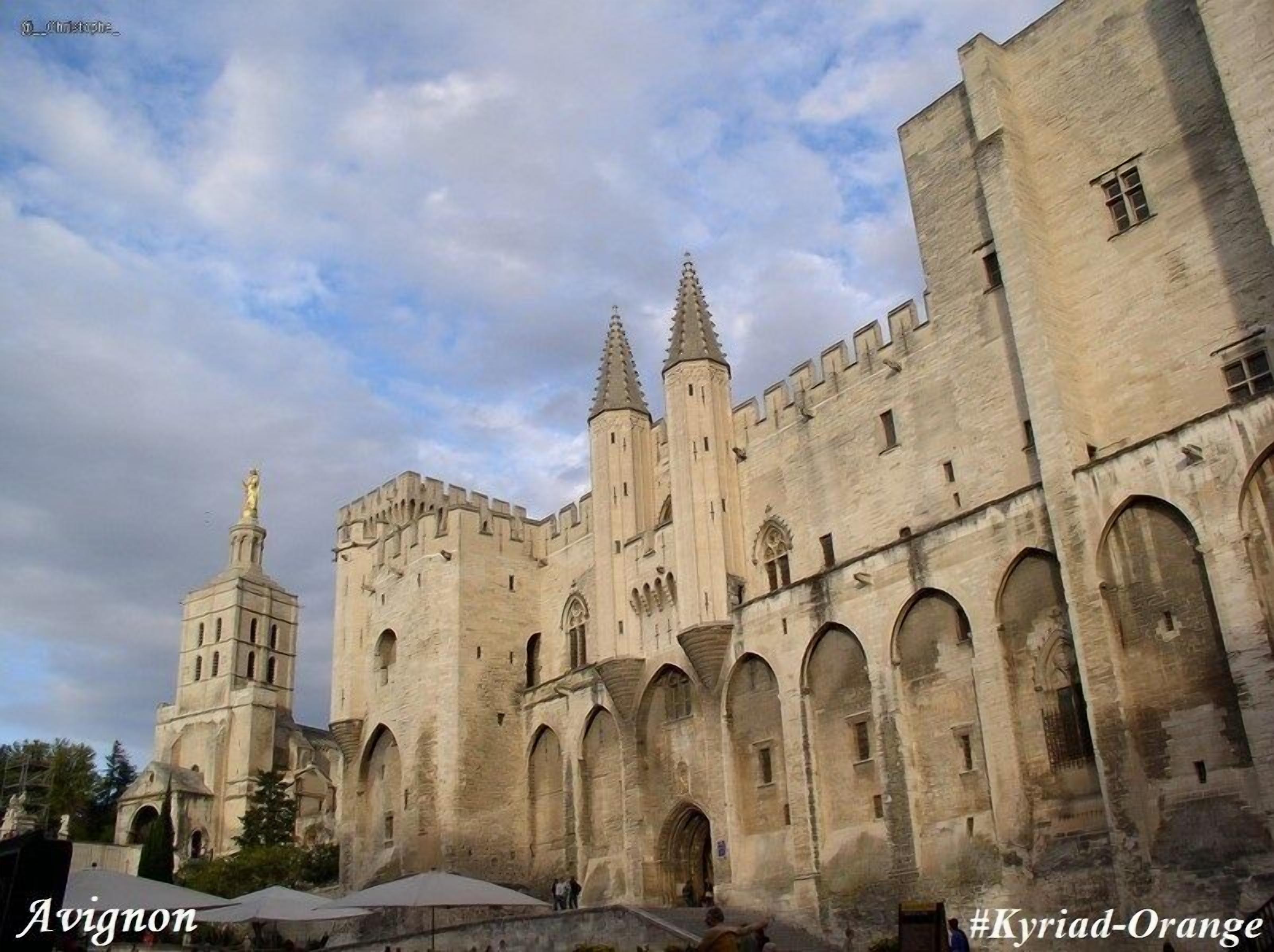 A historic stone castle with multiple towers and arched windows, located in Avignon.