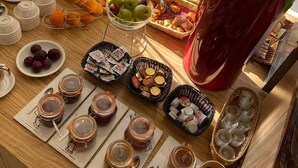 A breakfast buffet with various fruits, pastries, and condiments. - Kyriad Orange Centre (Orange)