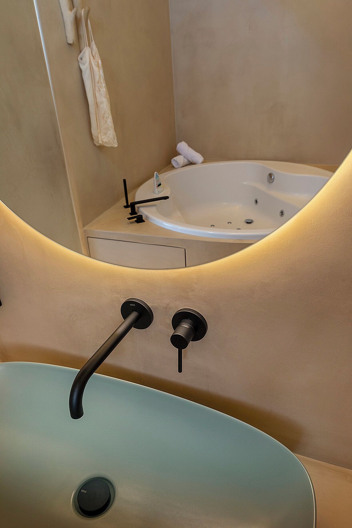 A bathroom with a bathtub, a sink, and a towel rack.