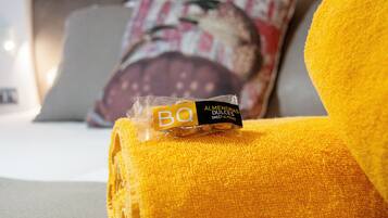 A package of BQ sweet almonds on a yellow cushion.
