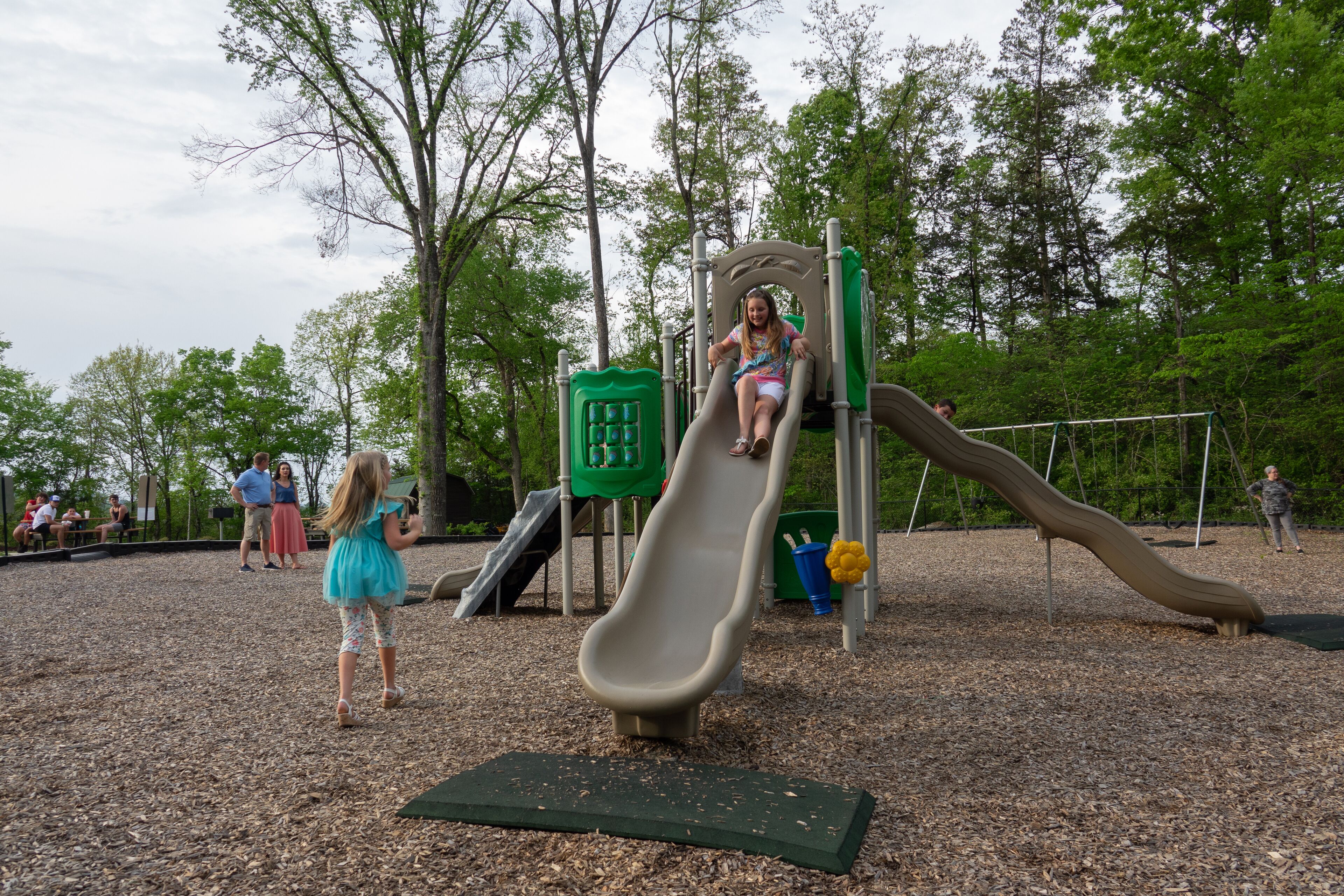 A playground with a slide and climbing structures.