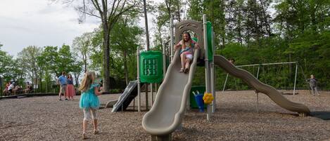 A playground with a slide and climbing structures.