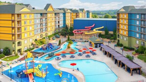 A hotel with multiple swimming pools, water slides, and a children's play area. - The Resort at Governor's Crossing (Sevierville)