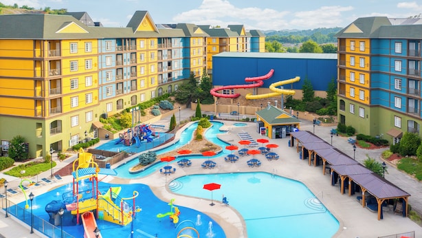 A hotel with multiple swimming pools, water slides, and a children's play area. - The Resort at Governor's Crossing (Sevierville)