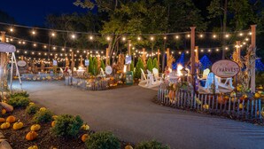 A decorated outdoor area with string lights, chairs, and pumpkins. - The Resort at Governor's Crossing (Sevierville)