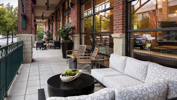 An outdoor seating area with a sofa, chairs, and a coffee table.
