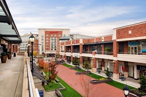 A Marriott hotel with a brick facade, outdoor seating, and a pedestrian walkway.
