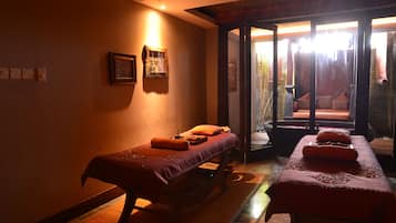 Relax in this serene retreat with a plush bed, massage table, and garden view.