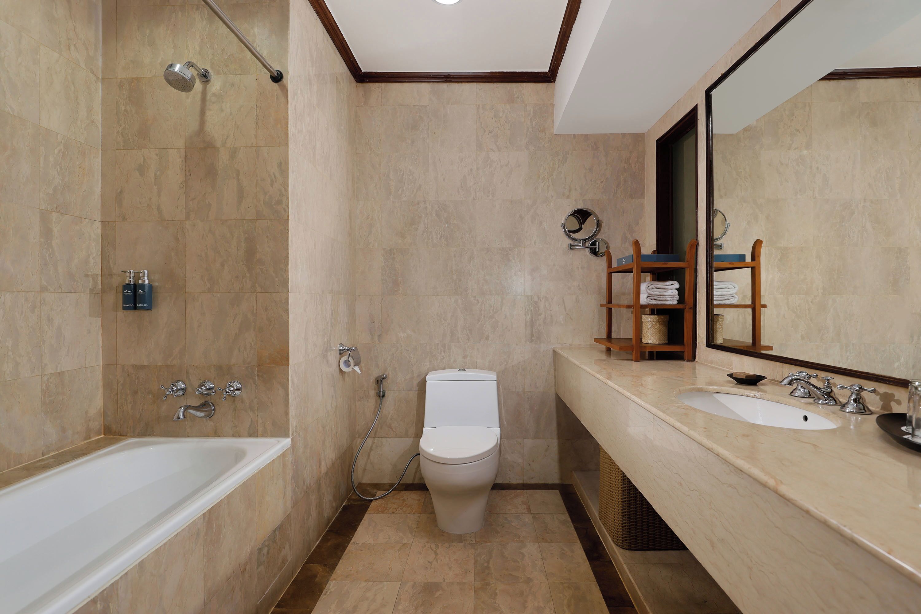 A modern bathroom with a bathtub, toilet, and vanity with a sink.