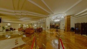 A spacious lobby with a marble floor, seating areas, and a chandelier. - Peerless Hotel Kolkata (Kolkata)