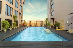 Outdoor pool, open 7:00 AM to 10:00 PM, pool umbrellas, sun loungers