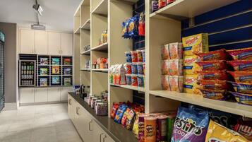 A well-stocked snack aisle with various brands and types of snacks.