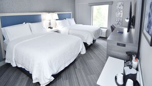 A hotel room with two beds, a desk, a TV, and a window. - Hampton Inn Auburn (Auburn)