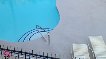 Seasonal outdoor pool, open 9:00 AM to 10:00 PM, pool umbrellas