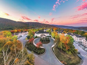 A residential area with a winding road, surrounded by autumn-colored trees and a backdrop of hills. - Vacation Village in the Berkshires (Williamstown)