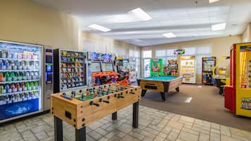 Enjoy games, snacks, and entertainment in our recreational area, featuring a foosball table, pool table, arcade games, and vending machines.