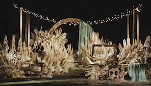 An outdoor setting with a rustic archway, string lights, and a table with chairs. - Holiday Inn Beijing Temple Of Heaven by IHG (Beijing)