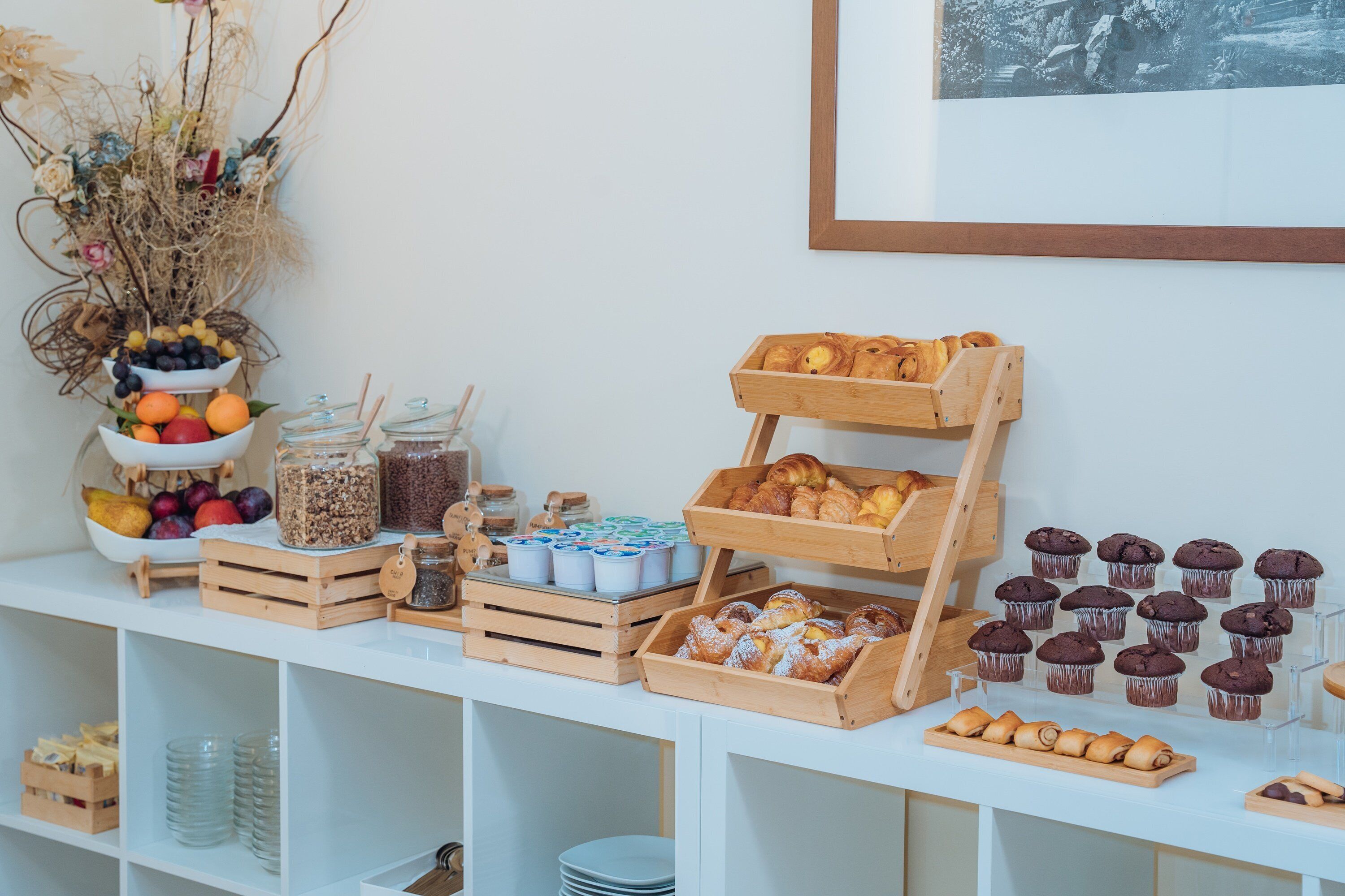 A buffet setup with various food items and containers.
