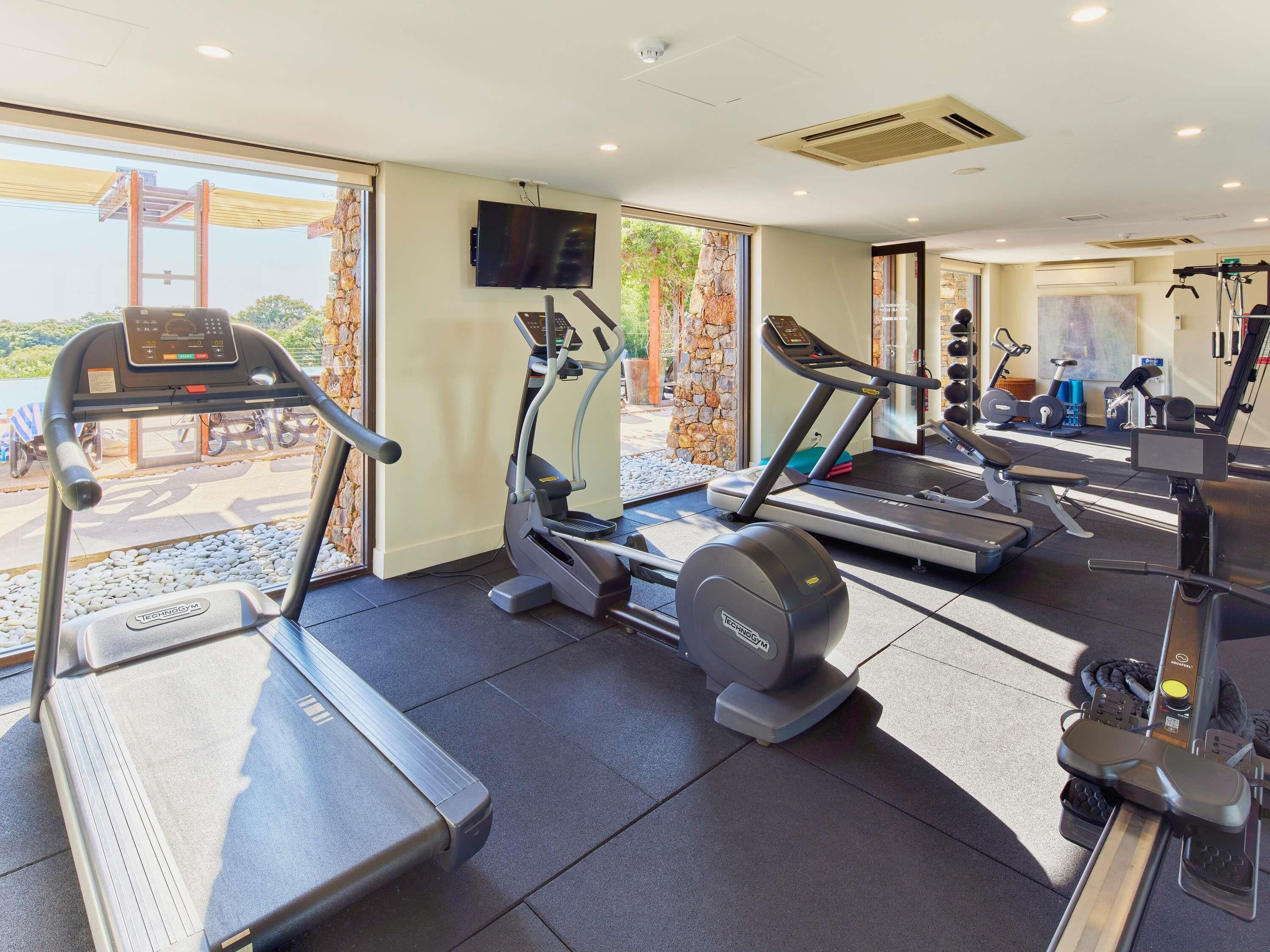 A gym with treadmills, ellipticals, and weight machines.