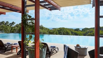An outdoor pool area with lounge chairs and a pergola.