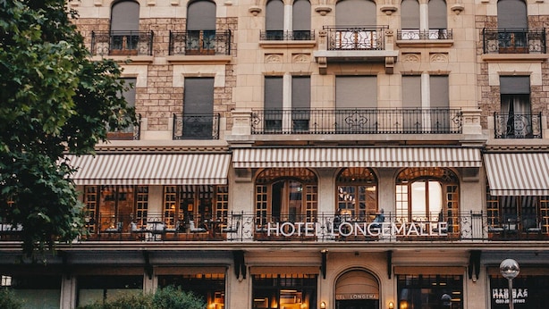 A historic hotel with a classic European architectural style, featuring multiple balconies and a prominent entrance. - Hôtel Longemalle (Geneva)