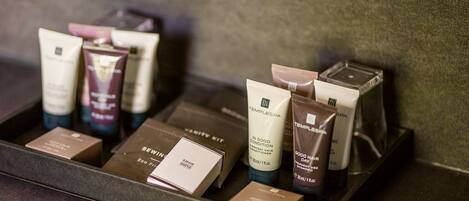 A tray with various toiletries including a tube labeled "TEMPLESPA" and several boxes.