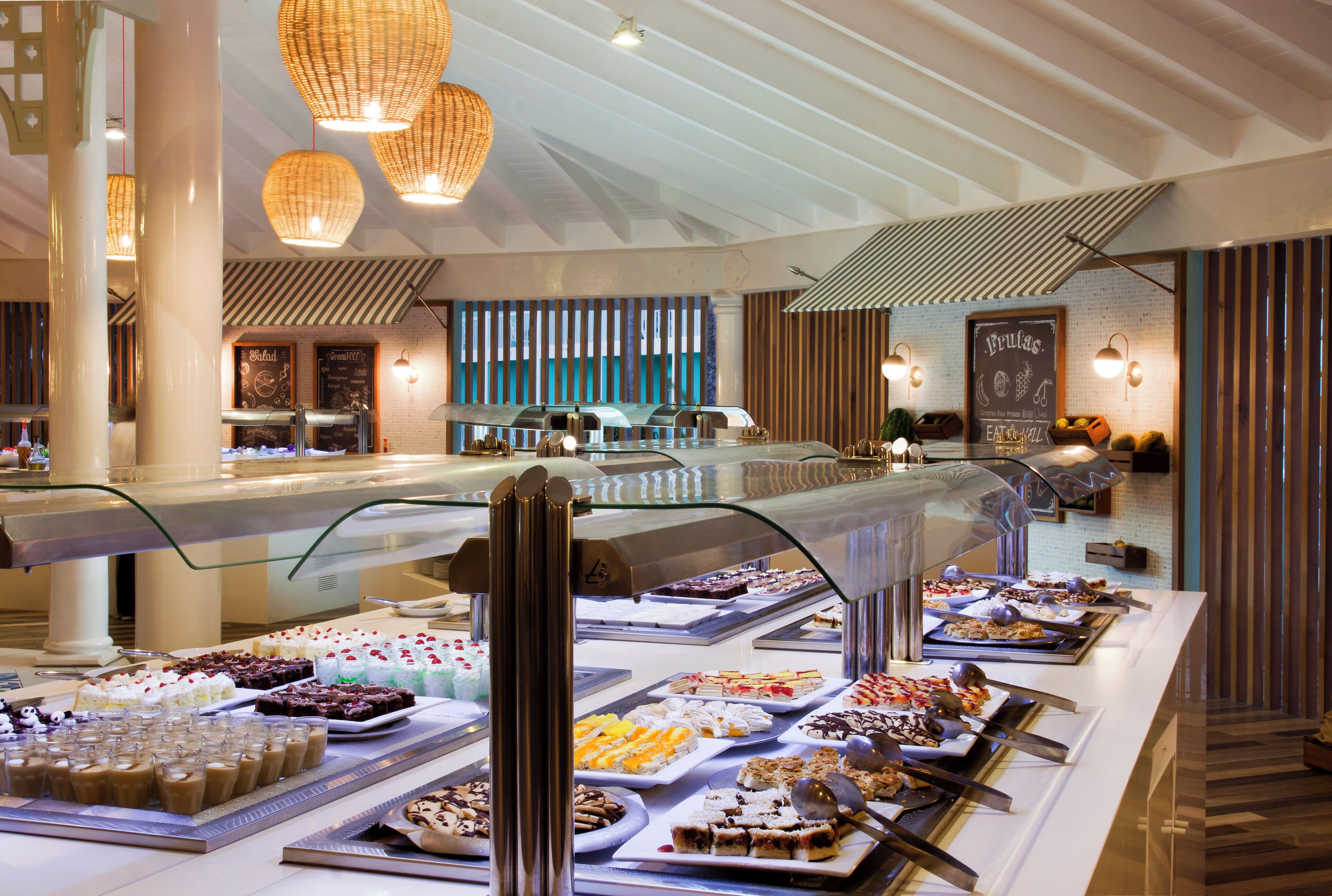 A buffet with various desserts and pastries displayed on trays.