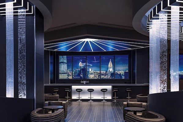 A modern bar area with a cityscape view, bar stools, and a unique ceiling design. - Disney Hotel New York - The Art of Marvel (Chessy)