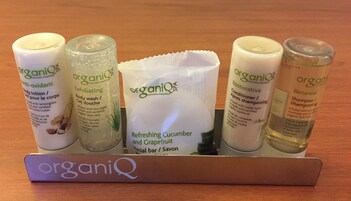 A set of organic personal care products on a wooden tray.