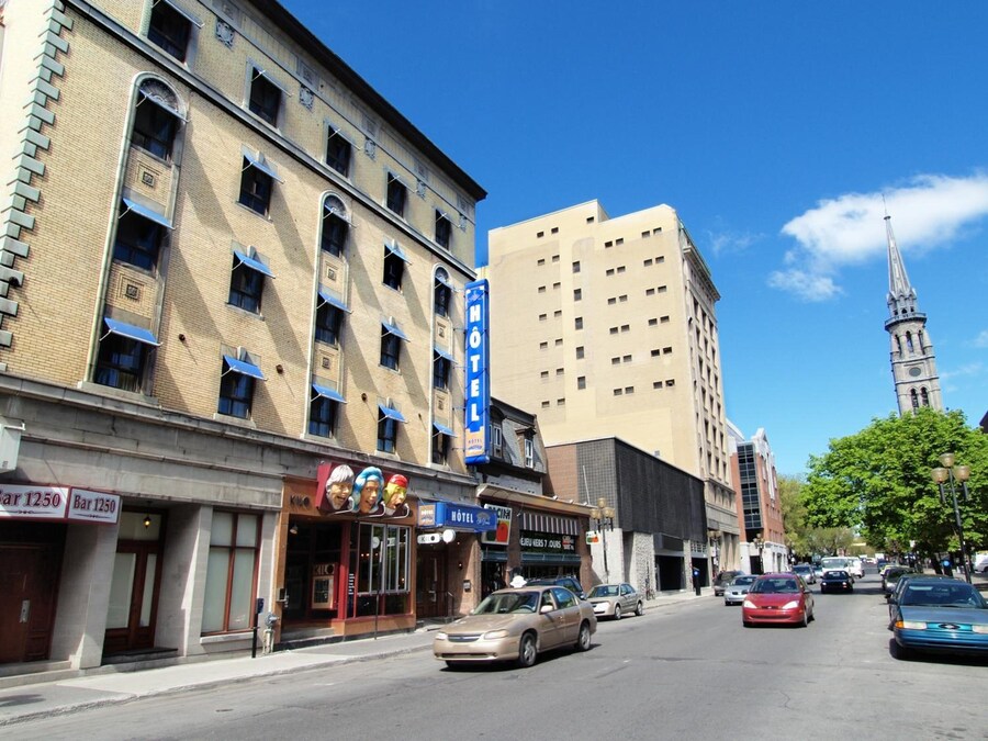 Street view of Rue Saint-Denis in Montreal with eclectic shops and vibrant atmosphere.