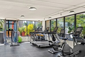 A gym with treadmills, stationary bikes, and exercise equipment. - Luana Waikiki Hotel & Suites (Honolulu)