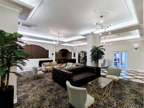 A spacious lobby with a central seating area, multiple columns, and a patterned carpet. - Premier Hotel The Richards (Richards Bay)