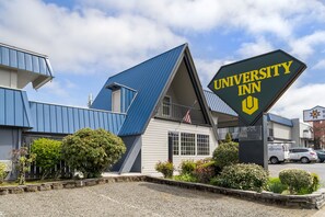A building with a sign reading "University Inn" and a pool area.