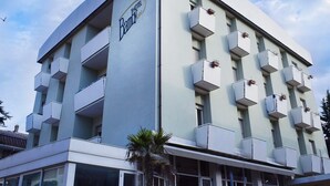 A modern hotel building with a light facade, multiple balconies, and a prominent 'Hotel Bamby' sign. - Hotel Bamby (Rimini)
