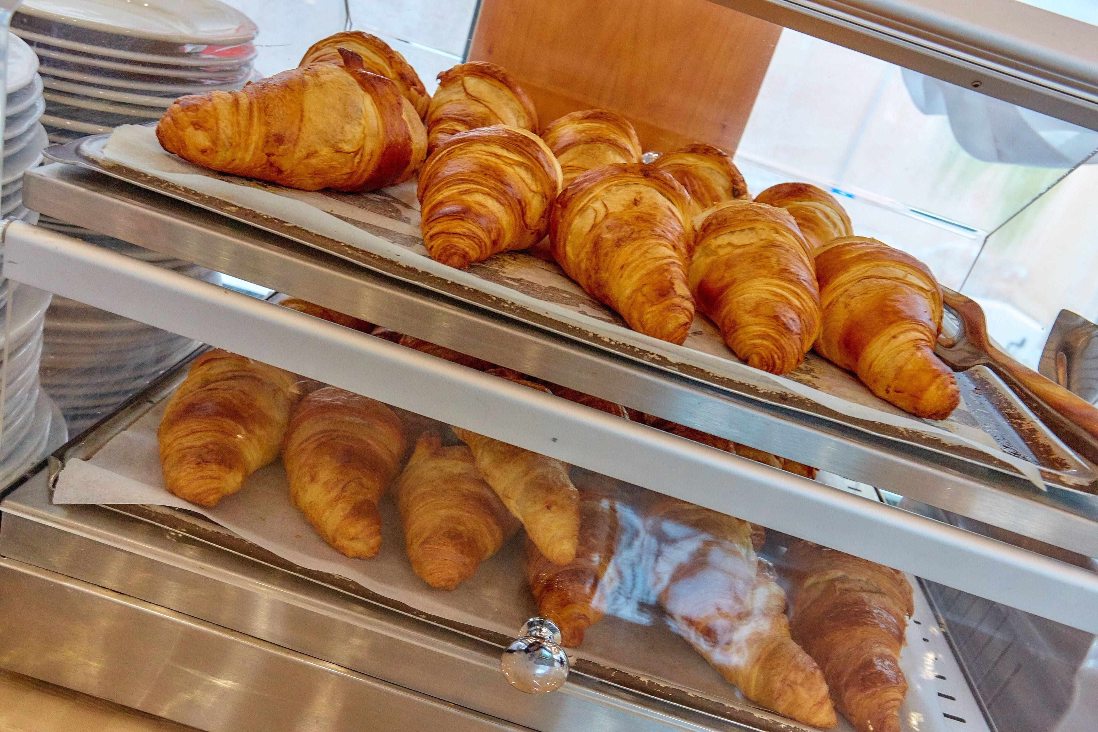 A display case with multiple croissants.