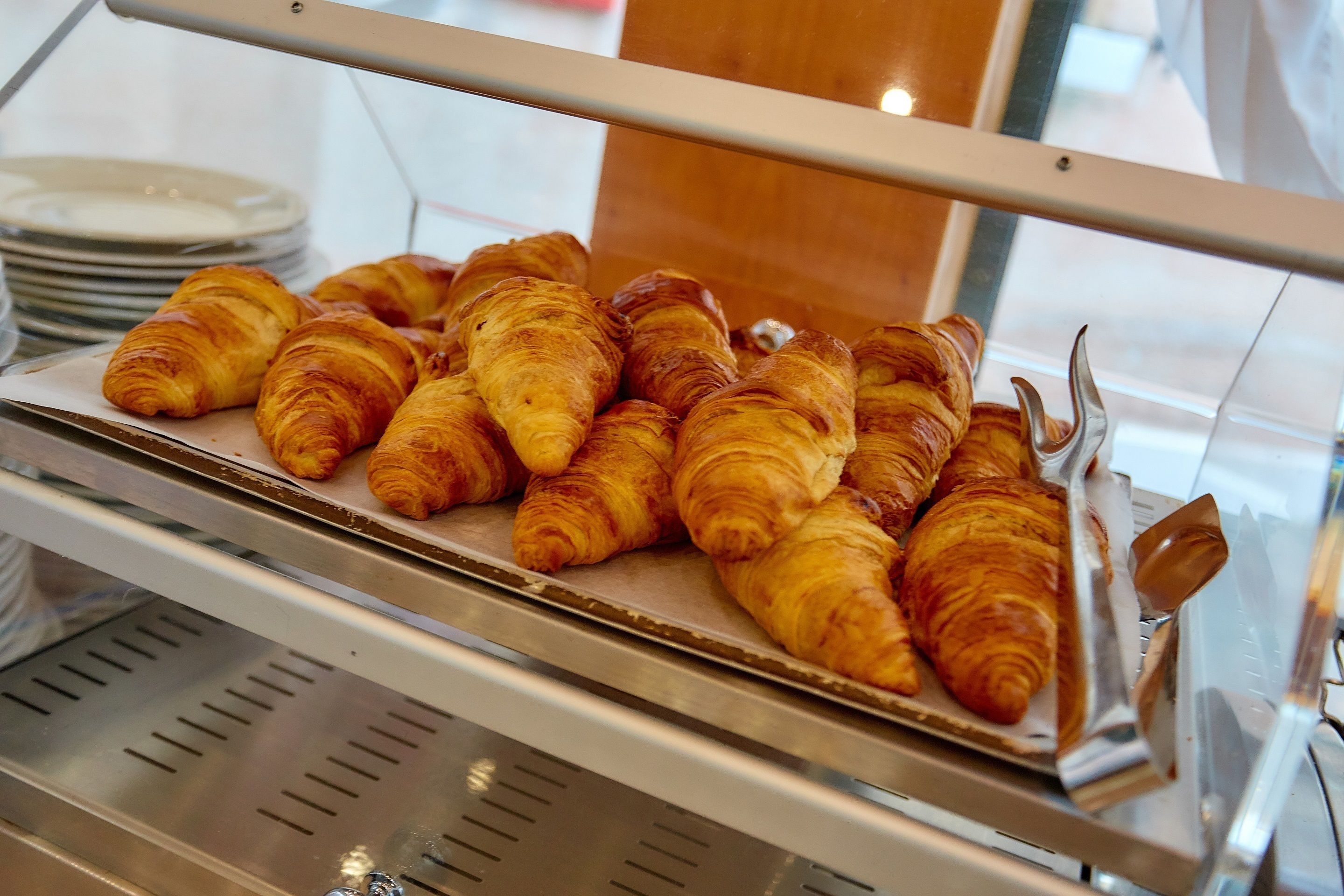 A display case with freshly baked croissants.