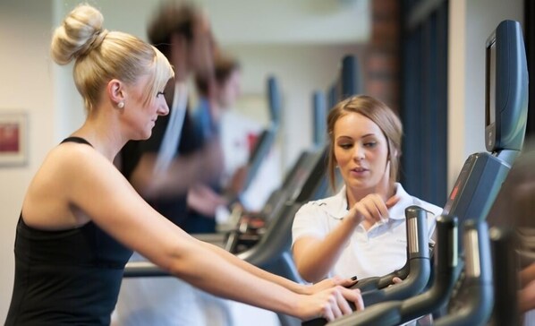 A gym with treadmills and a person using one. - Champneys Springs (Ashby-de-la-Zouch)