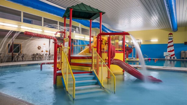 An indoor water park with a play structure, slides, and a pool. - Days Inn by Wyndham Fargo/Casselton Waterpark (Casselton)