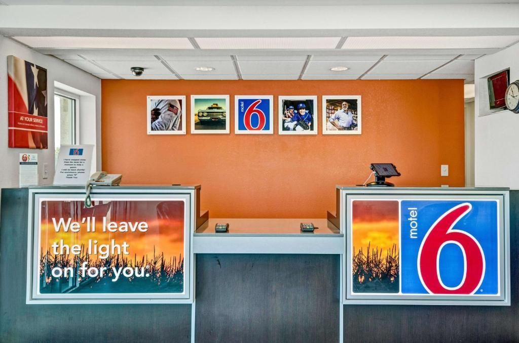 A reception desk with a sign that reads 'We'll leave the light on for you.'