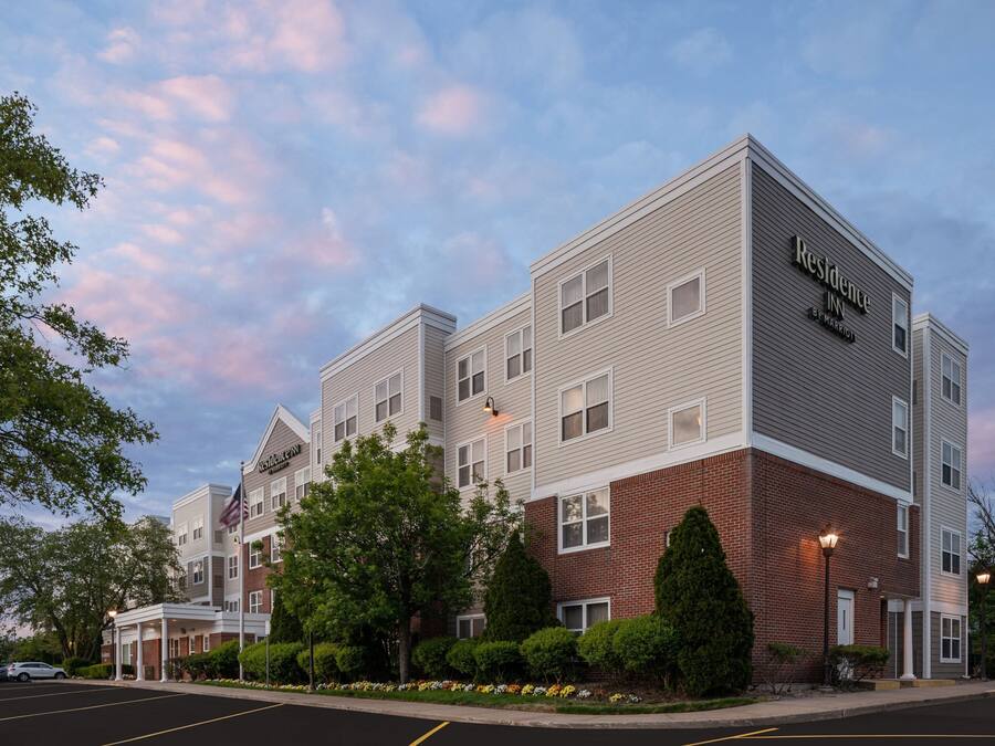 A multi-story hotel with a brick facade and a flat roof.