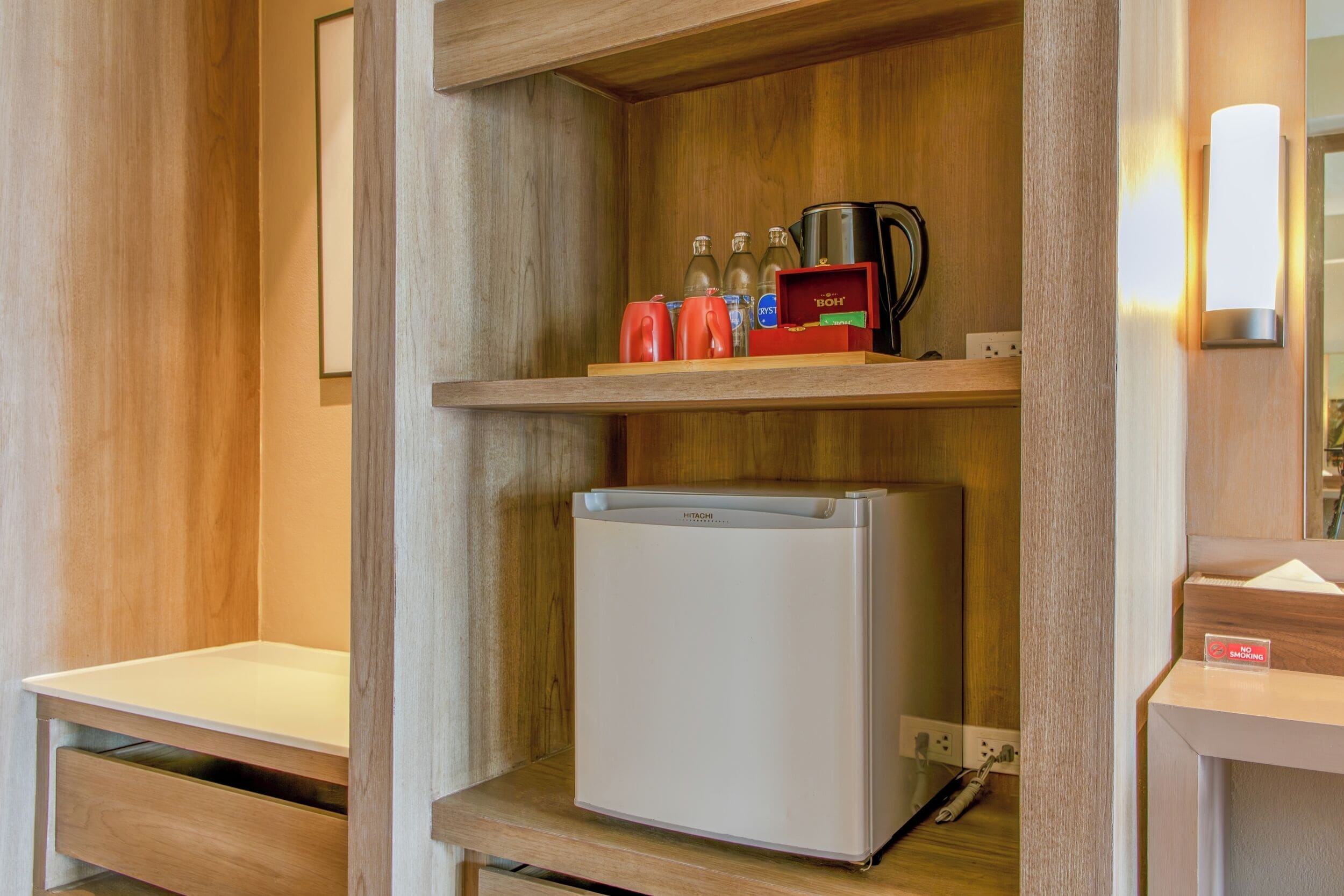 A compact kitchenette with a built-in refrigerator, a coffee maker, and a toaster.