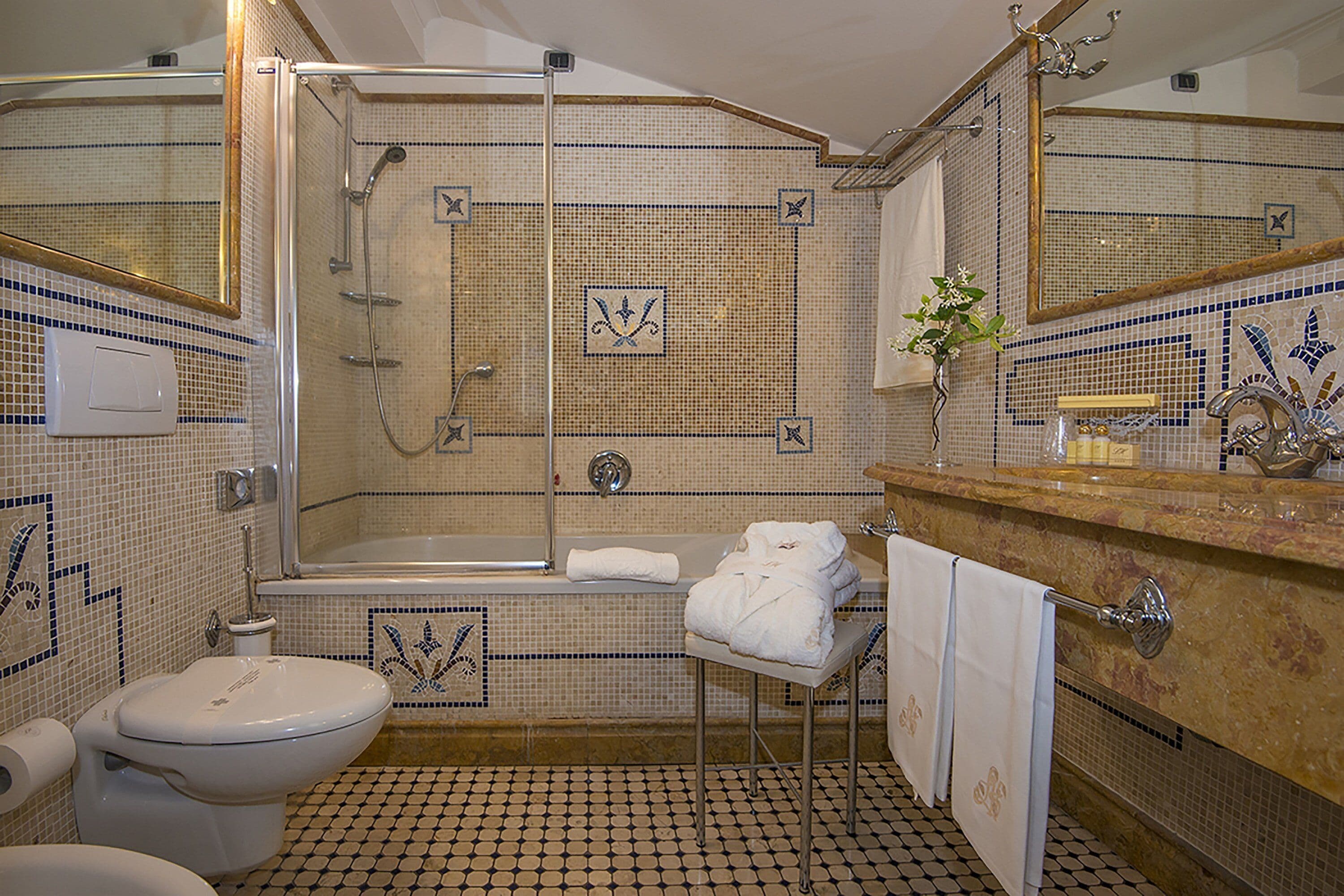 designer toiletries, hair dryer, slippers, bidet